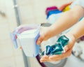 Girl wash laundry with different detergent Royalty Free Stock Photo