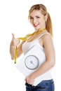 Woman with bathroom scale and measuring tape Royalty Free Stock Photo