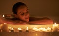 Woman, bathtub and candles for spa care with relax cleaning routine with bubbles for treatment, hygiene or wellness