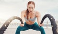 Woman, battle rope exercise and portrait at ocean park for fitness, strong body and wellness at outdoor training. Girl