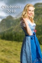 Woman in a bavarian dirndl and the text `Oktoberfest 2018`