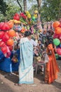 Woman baying colorful toys for her children from vendor