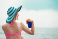 Woman on beach applying sun block creme Royalty Free Stock Photo