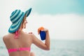 Woman on beach applying sun block creme Royalty Free Stock Photo