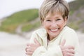 Woman at the beach cold and smiling