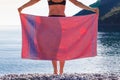 Woman on beach covering hips with towel Royalty Free Stock Photo