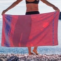 Woman on beach covering hips with towel Royalty Free Stock Photo