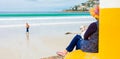 Woman at a beach with a dog on her lap Royalty Free Stock Photo