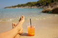 Woman on the beach, drinking coctail in the water, enjoying summer Royalty Free Stock Photo