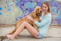A woman on the beach with her Chocker Spaniel in front of a graffiti wall. Royalty Free Stock Photo
