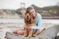 A woman on the beach with her Chocker Spaniel