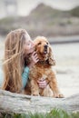 A woman on the beach with her Chocker Spaniel