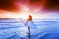 Woman on beach holding surfboard Royalty Free Stock Photo