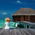 Woman on a beach jetty at Maldives Royalty Free Stock Photo