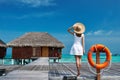 Woman on a beach jetty at Maldives