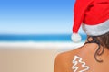 Woman on the beach in santas hat Royalty Free Stock Photo