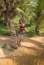 Woman on the beach sitting palm tree