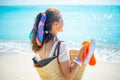 Woman with beach straw bag, orange flip flops and bottle of spf Royalty Free Stock Photo