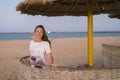 woman on the beach taking deep breath enjoying fresh air freedom. Happy young woman enjoying sea breeze at sunset. Girl on the Royalty Free Stock Photo