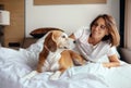 Woman and beagle dog wake up and meet new day in bed Royalty Free Stock Photo