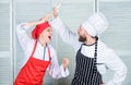 Woman and bearded man culinary show competitors. Ultimate cooking challenge. Culinary battle of two chefs. Couple Royalty Free Stock Photo