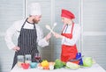 Woman and bearded man culinary show competitors. Who cook better. Ultimate cooking challenge. Culinary battle of two Royalty Free Stock Photo