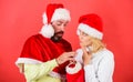 Woman and bearded man in santa hat expecting gift red background. Check contents of christmas stocking gift received Royalty Free Stock Photo