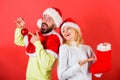 Woman and bearded man in santa hat expecting gift red background. Check contents of christmas stocking gift received Royalty Free Stock Photo