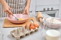 Woman beats eggs in a bowl. housewife cooking on kitchen