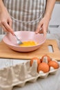 Woman beats eggs in a bowl. housewife cooking on kitchen