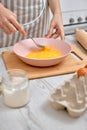 Woman beats eggs in a bowl. housewife cooking on kitchen