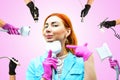 A woman beautician against the background of a collage of handpieces for carrying out hardware slimming procedures in a spa salon. Royalty Free Stock Photo