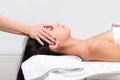 Woman beautician doctor make head massage in spa wellness center