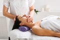 Woman beautician doctor make head massage in spa wellness center Royalty Free Stock Photo