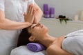 Woman beautician doctor make head massage in spa wellness center Royalty Free Stock Photo