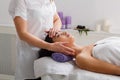 Woman beautician doctor make head massage in spa wellness center Royalty Free Stock Photo