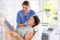 Woman beautician examining face skin of female patient before cosmetology procedure in clinic Royalty Free Stock Photo