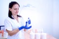 Woman cosmetician in gloves and with cream