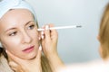 Woman at a beauticians appointment. A specialist examines it and makes markings with a special pencil. Non-surgical face