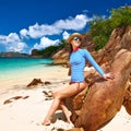 Woman at beautiful beach wearing rash guard