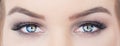 Woman with beautiful blue eyes with long eyelashes. hypnotic look closeup. smoky eyes make up
