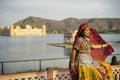 Woman in beautiful clothes posing at Jal Mahal Palace in Jaipur India Royalty Free Stock Photo