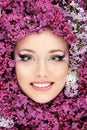 Woman beautiful face with flower lilac