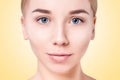Beauty Woman face portrait. Model girl posing in studio at yellow background. Female, cleansing. Royalty Free Stock Photo