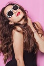 Woman with beautiful hair wearing sunglasses and posing