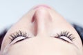 Woman beautiful long eyelashes made in cosmetics salon, macro photography of pretty female eyelashes and part of face