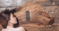 Woman with beautiful long hair on wooden background. Long hair. Beautiful hair coloring woman. Fashion haircut.