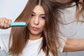 Woman With Beautiful Long Straight Hair Using Hair Straightener Royalty Free Stock Photo