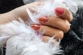 Woman with beautiful manicured red fingernails gracefully crossing her hands to display them to the viewer on a white Royalty Free Stock Photo