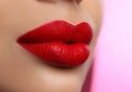 Woman with beautiful perfect lips after permanent makeup procedure on pink background, closeup Royalty Free Stock Photo